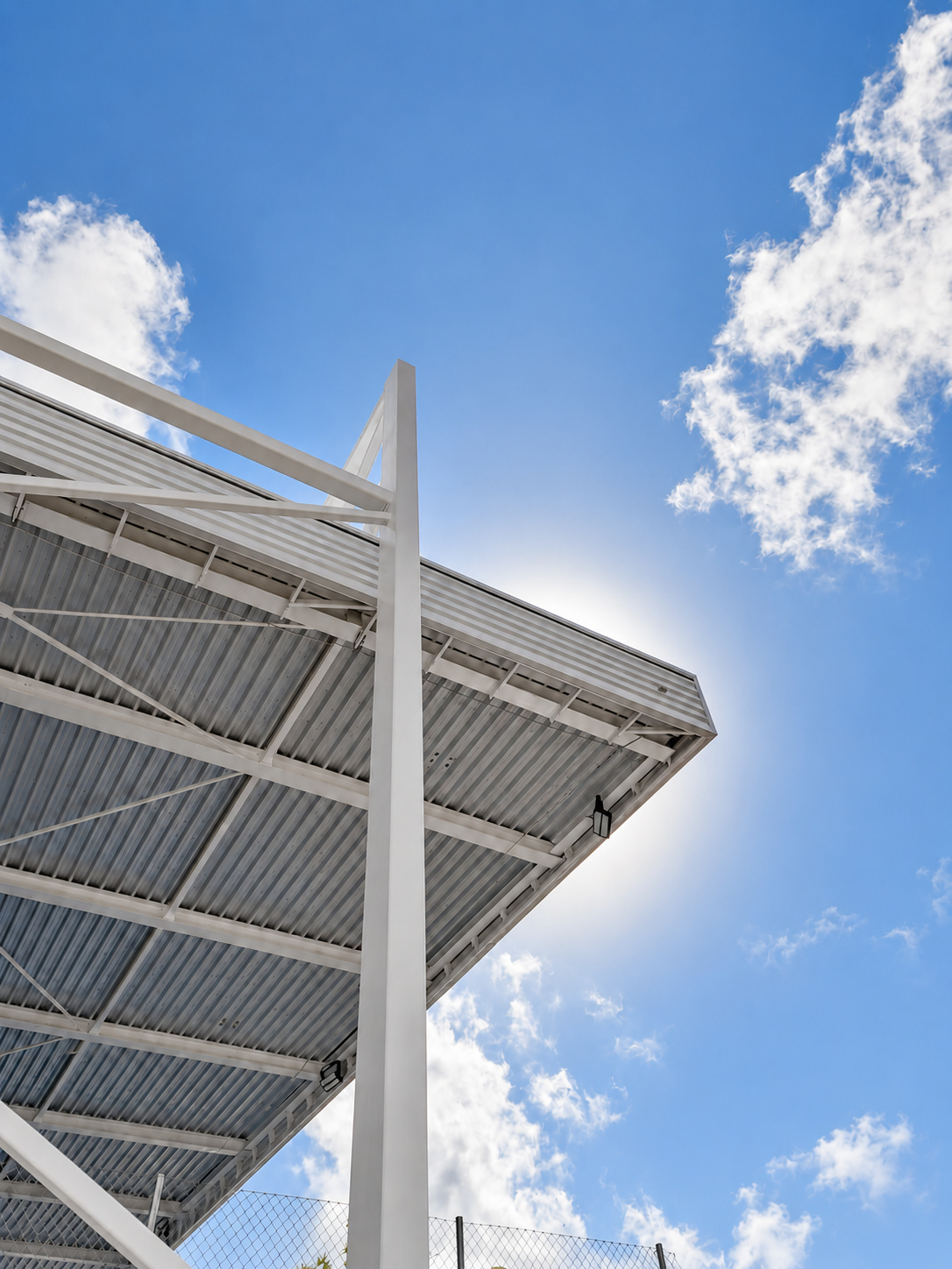 Low-angle view of the white steel column and sports roof in Teulada